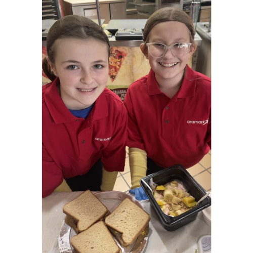 Two kids cooking and smiling